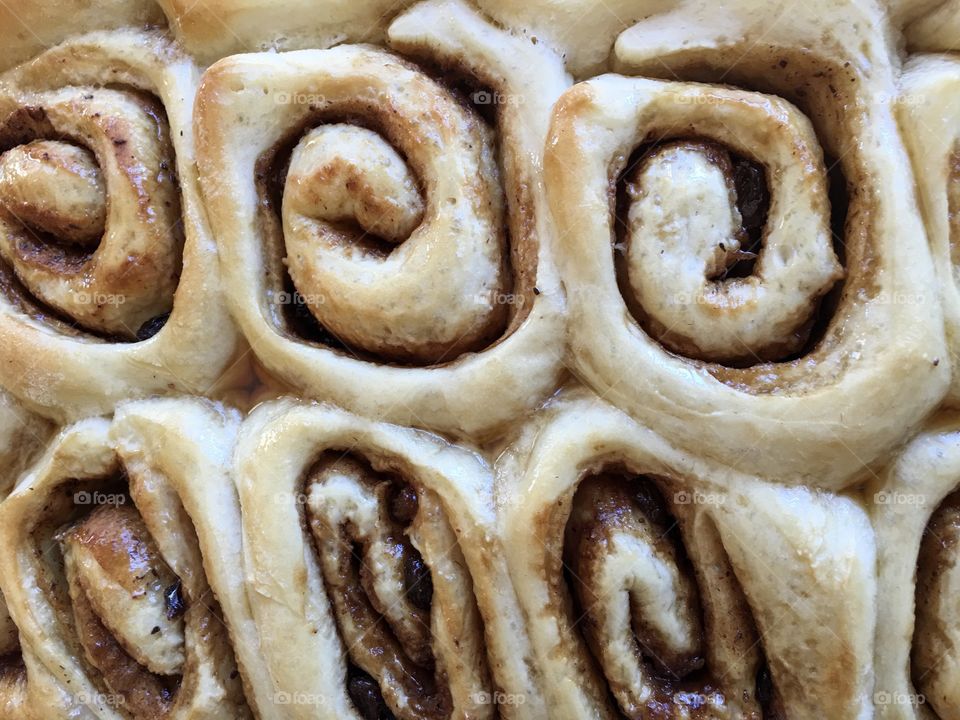 Cinnamon rolls scrolls topped with maple syrup glaze