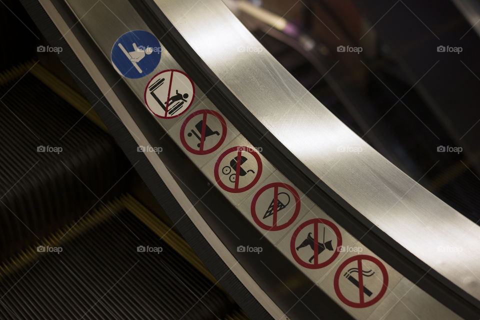 warning signs on escalator.  close up