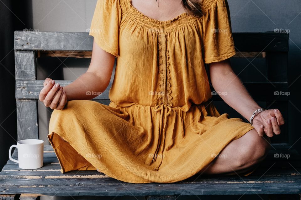 Girl in yellow dress doing morning yoga