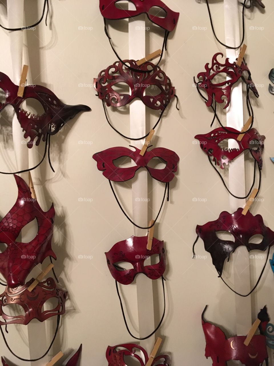 Display of leather masks in red against a white background 