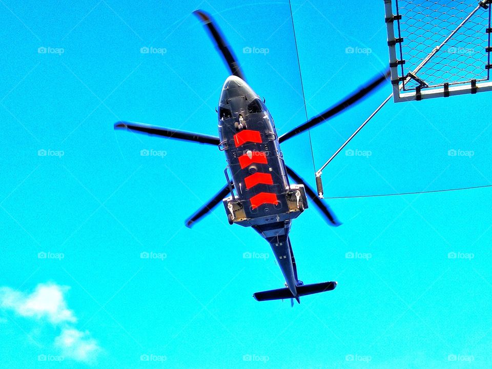 The helicopter on the blue sky in offshore