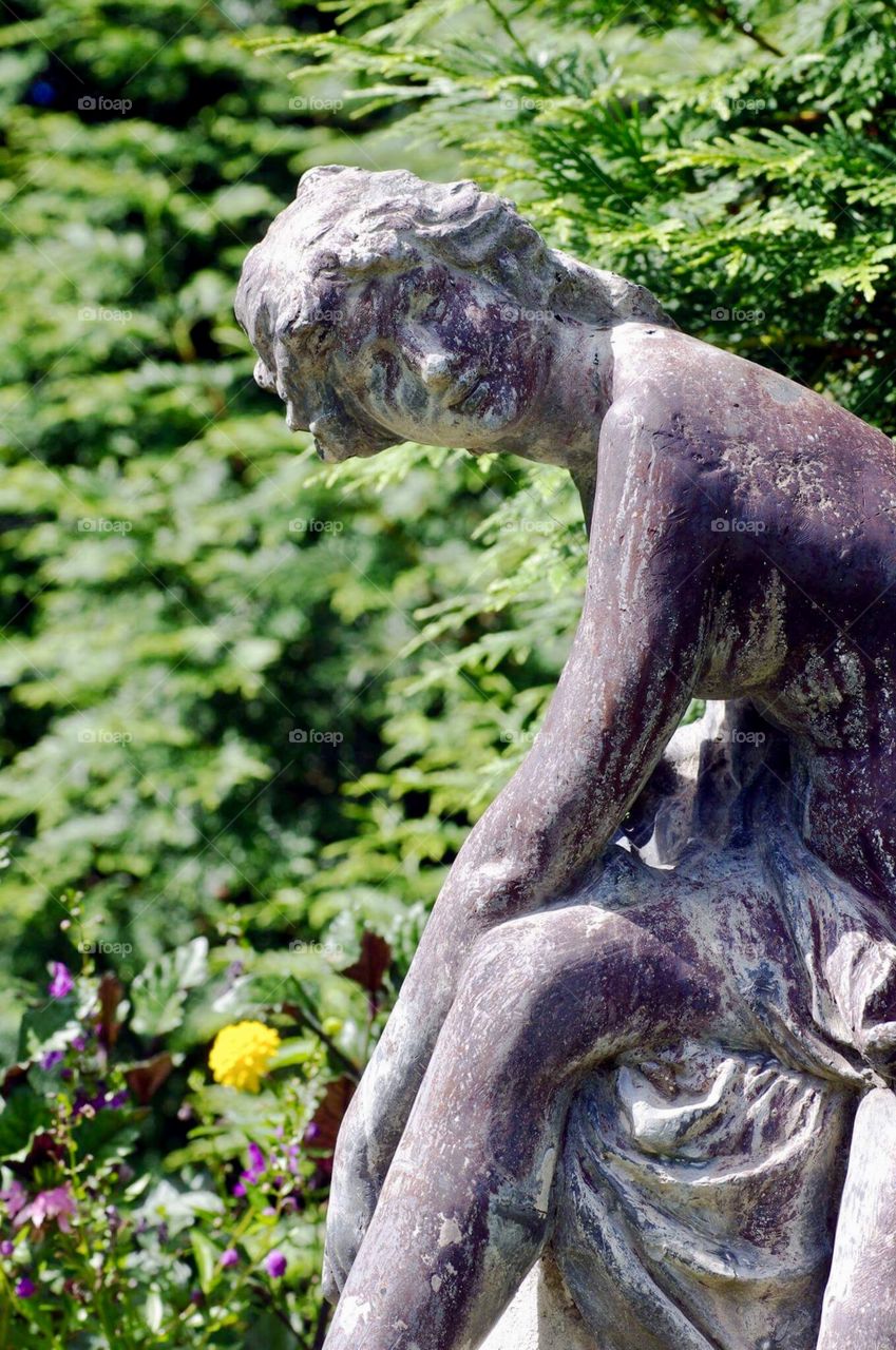 Statue of woman in  garden 