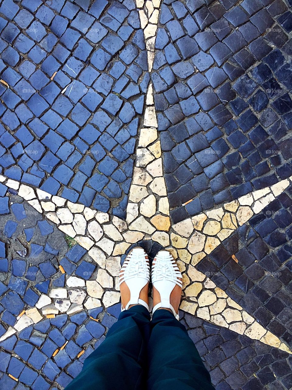 Feet selfie with cobble stone paving in the background 
