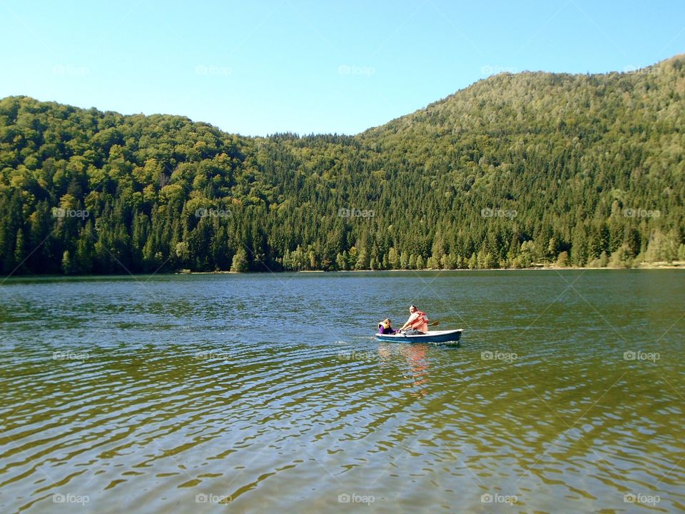 Boat sailing on the lake in summer