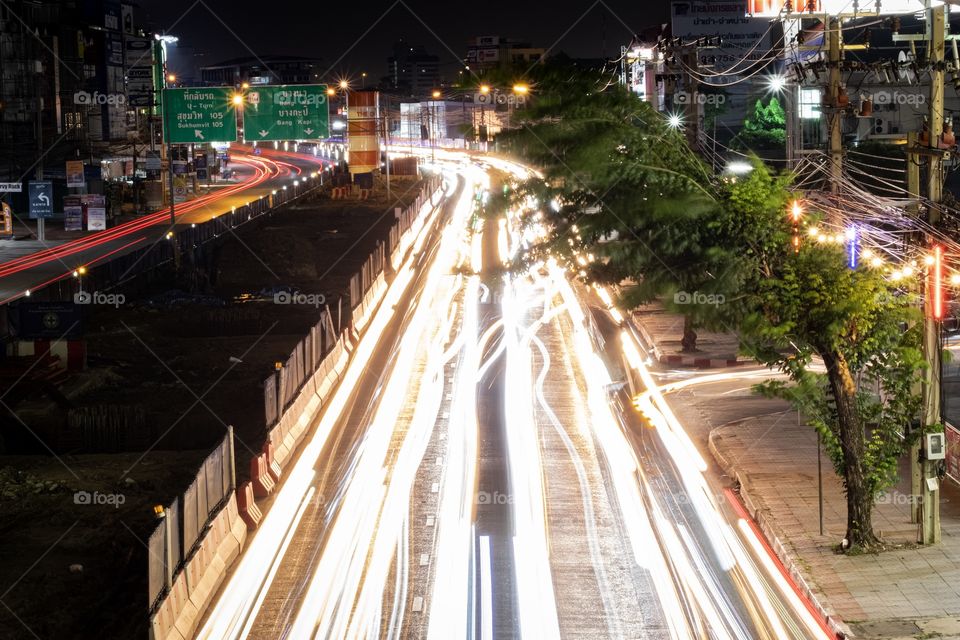 Vehicle lamp make beautiful line on road when drivers are driving back to home in evening 