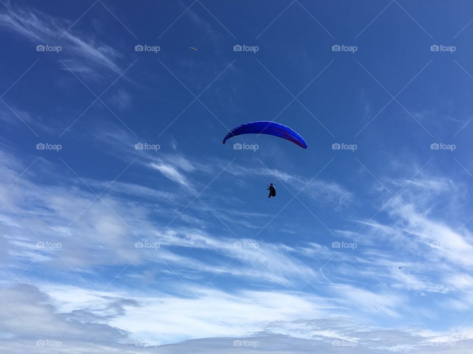 A human flying in parachute