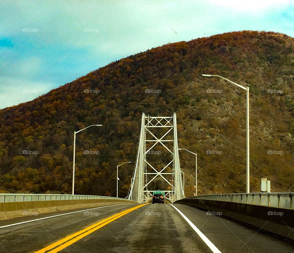 Bridge in upstate New York with a scenic mountain in the background. 