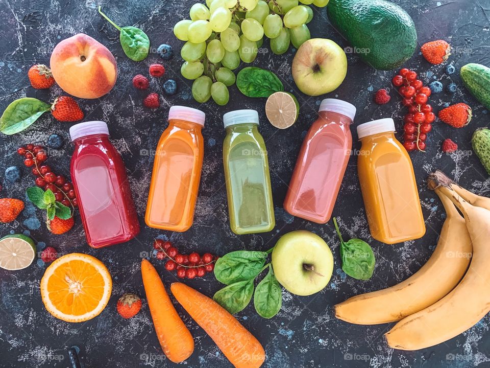 Smoothie bottles with fruits and berries 