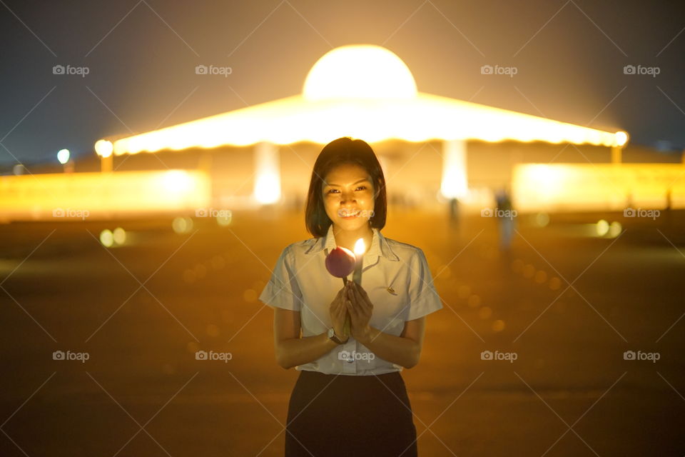 Dhammakaya pagoda and a girl pray for peace in Thailand 