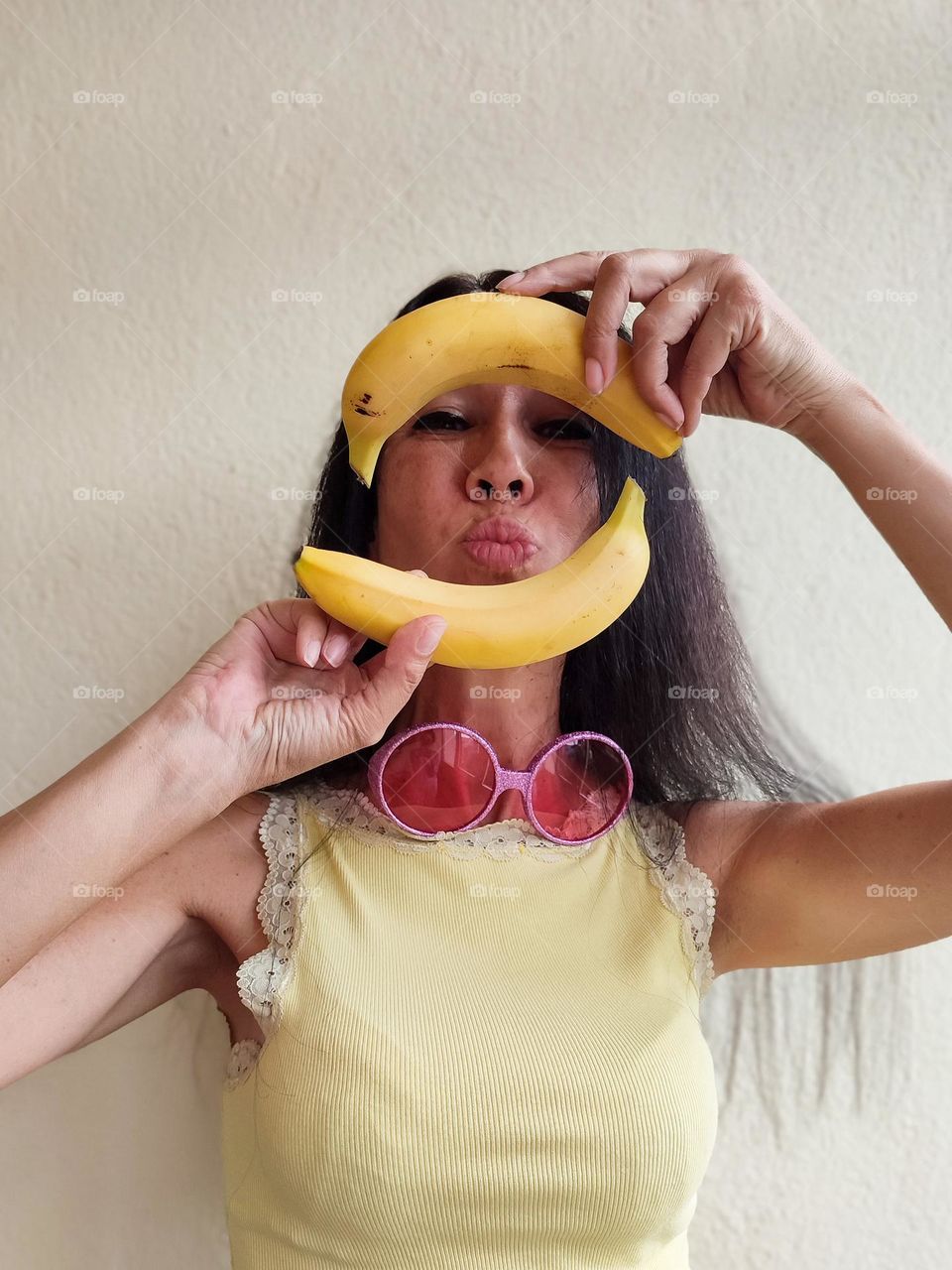 Funny Portrait of Beautiful Smiling Woman with bananas