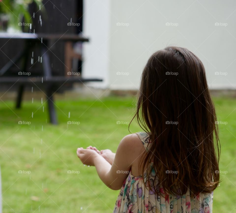 Little girl playing in rain