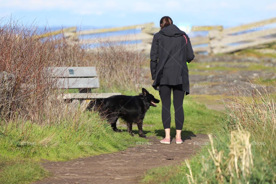 Woman and dog walking and talking 