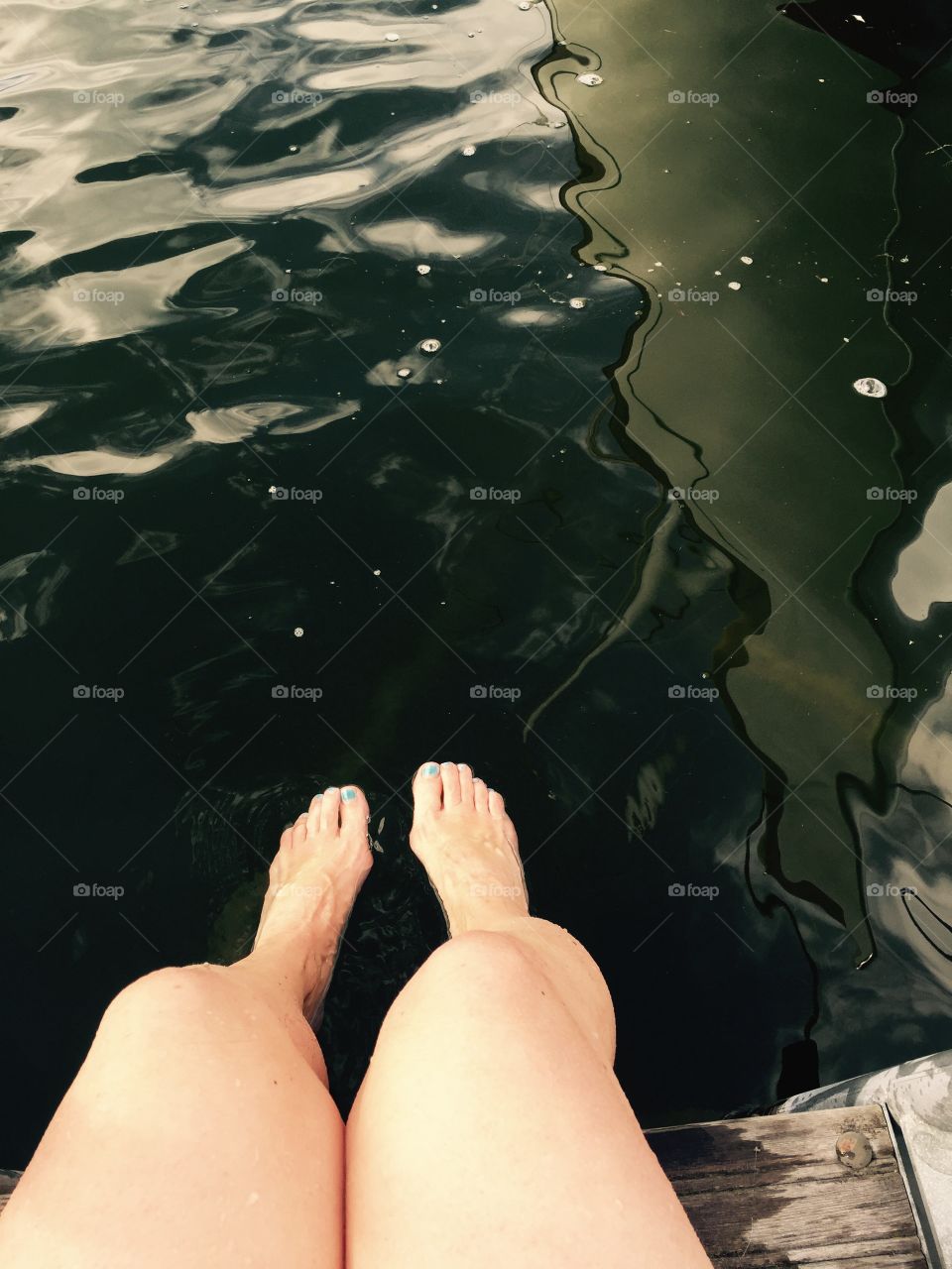A girl's feet over the water