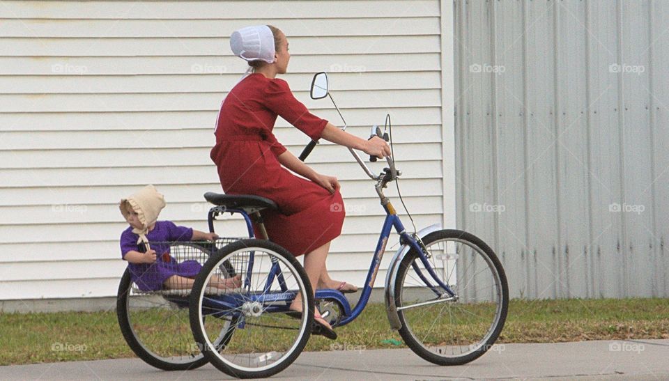 Mother on an adult tricycle transporting her daughter.in Sarasota, Florida
