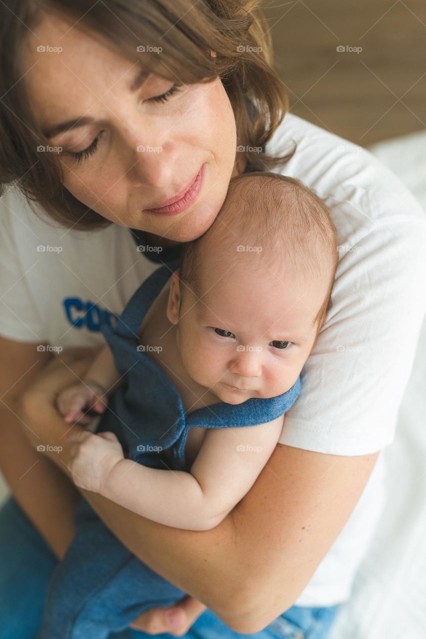 beautiful mother and six-month-old son, tender family photos, family spending time at home
