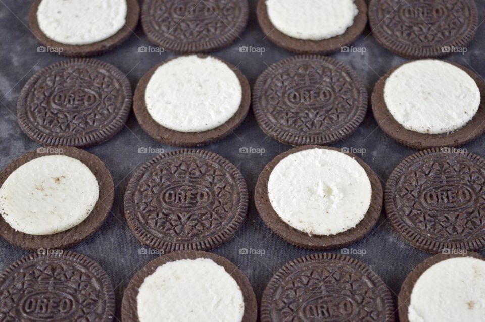 Contrasting Oreo cookies on a black background 