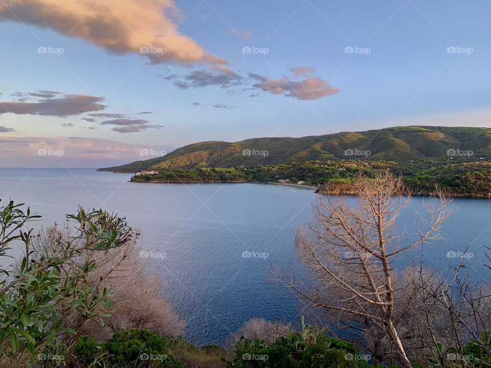 evocative image of the bay of Porto Azzurro at sunset