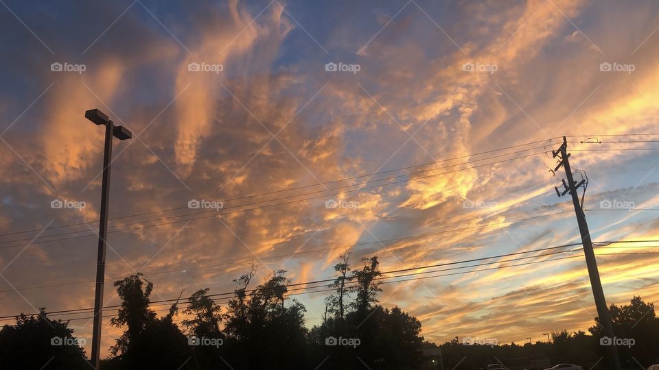 beautiful sky landscape silhouette sunset yellow orange blue trees and power lines
