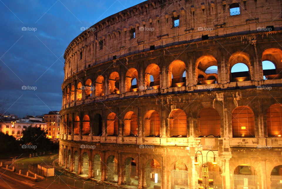The Colosseum at Dusk. Climbing the hilly area nearby, we waited for the sun to set and the evening lights to turn on the Roman night.