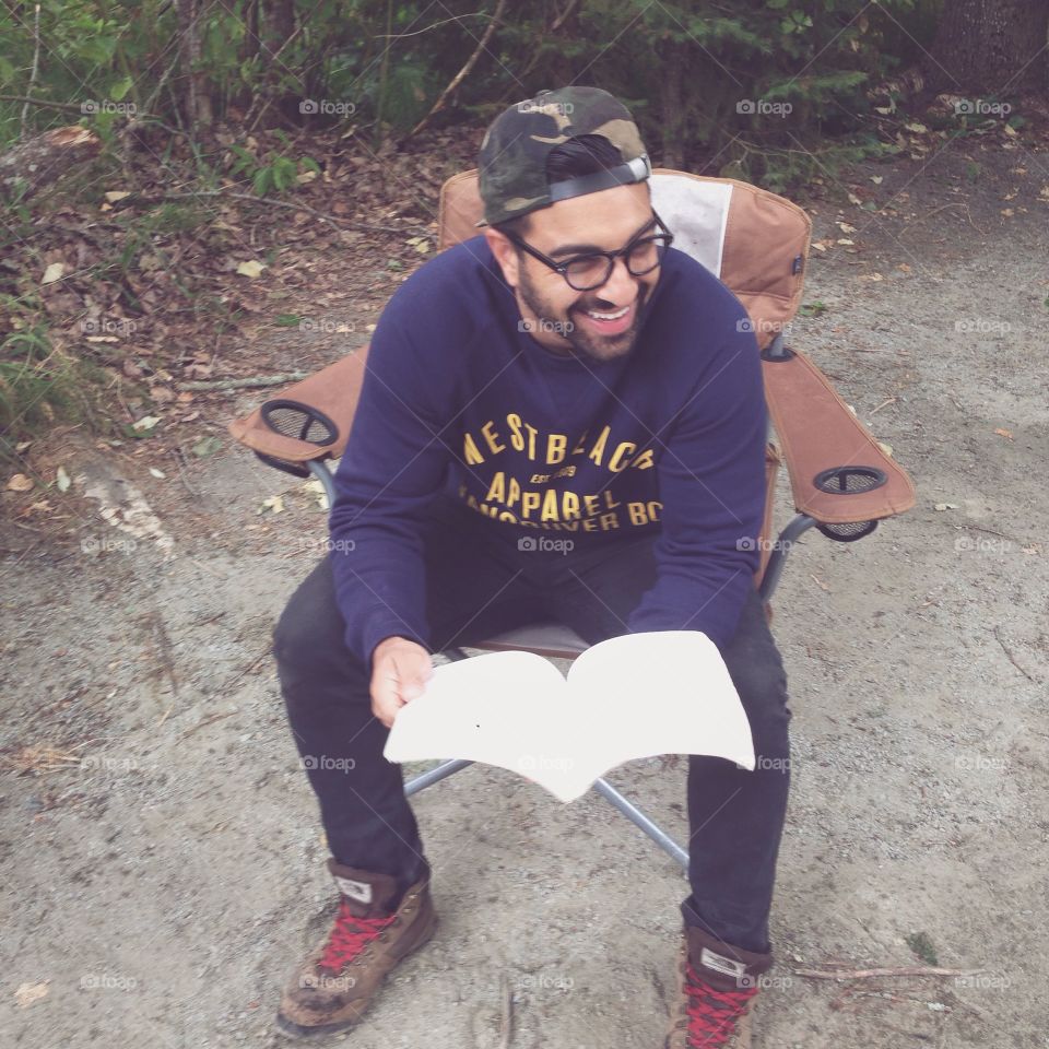 Hot dude reading. Hot dude reading while camping in the outdoors in Canada. 