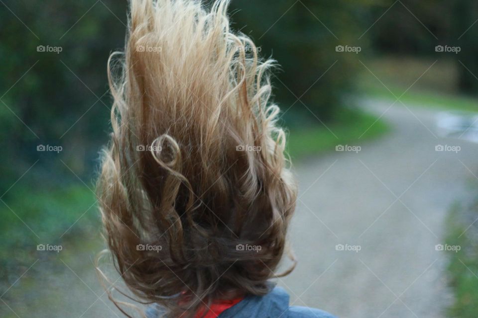 Flowing hair of a little girl jumping
