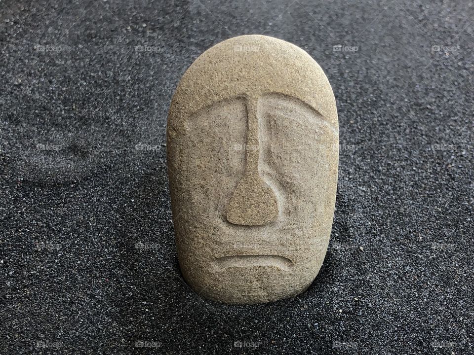 Stylized Moai carved on a stone as unique souvenir of Easter Island, Chile, South America 