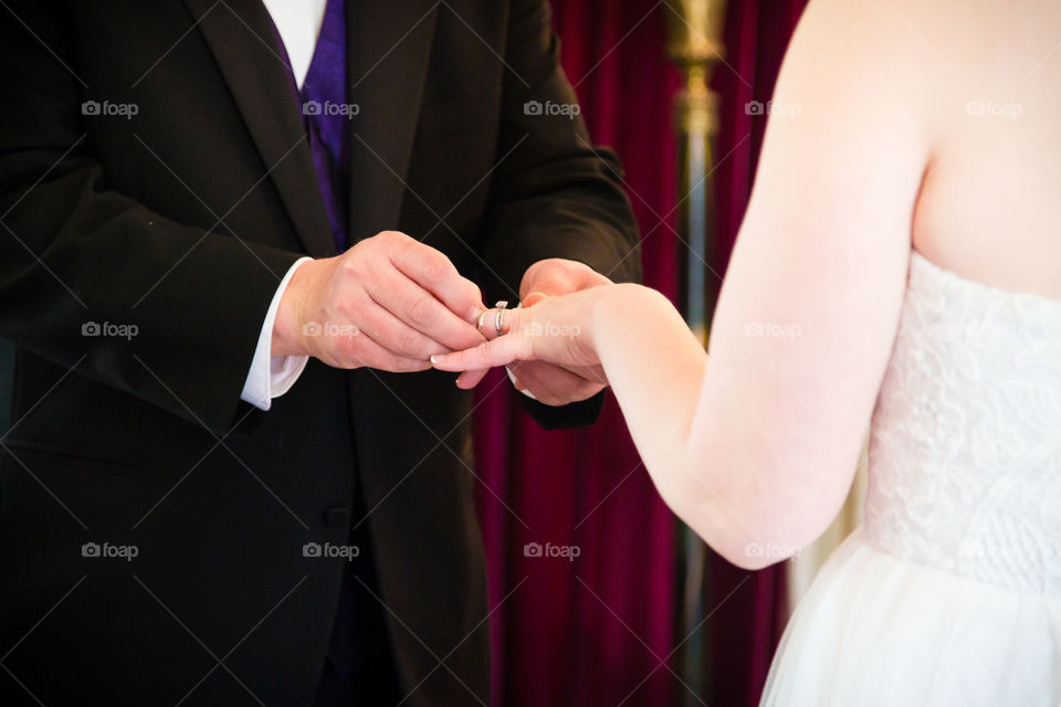 Wedding ceremony ring exchange with bride and groom
