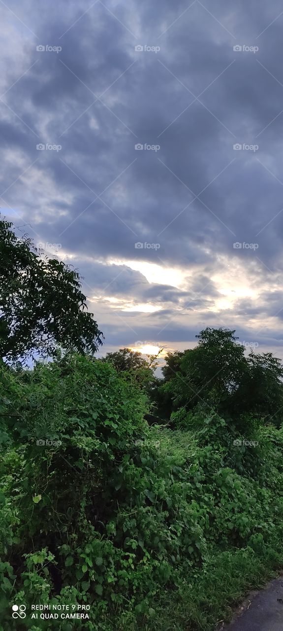 The sun hiding in the clouds looks like someone is blowing fire