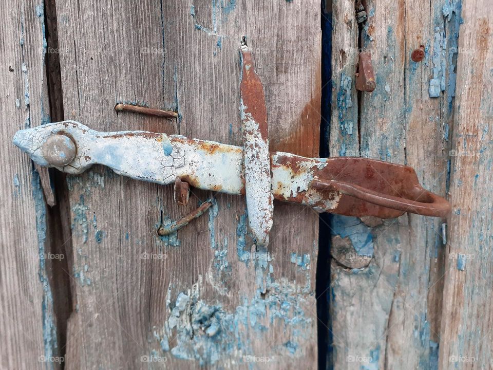 An ancient metal door handle called a doorknob