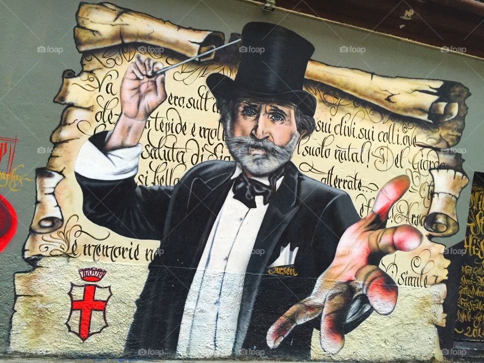 Old man painting on the wall