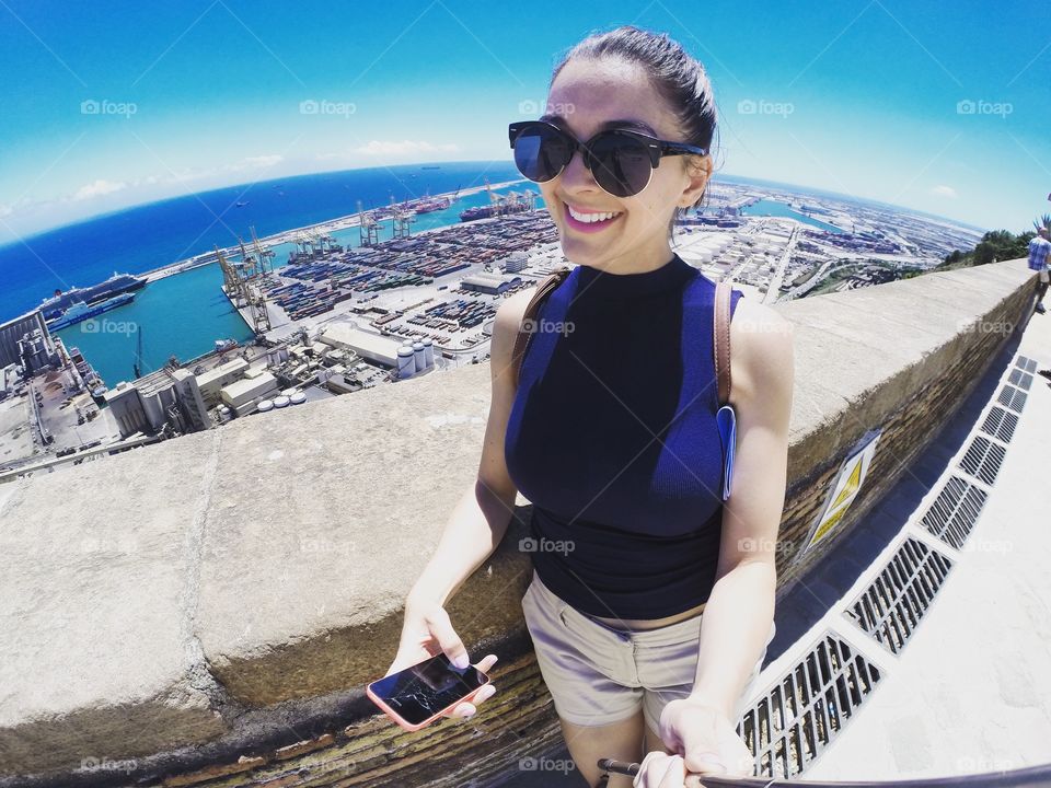 Traveling the world with a selfie stick. Me in Barcelona, Spain viewing the beautiful harbour front. 