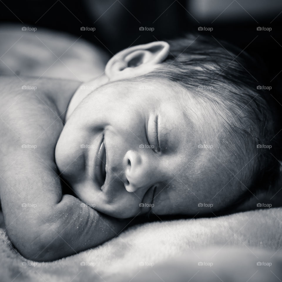 Baby sweet dream. Cute newborn baby smilling while sleeping
