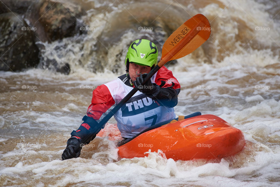 Helsinki, Finland - April 15, 2018: Unidentified racer at the annual Icebreak 2018 whitewater kayaking competition at the Vanhankaupunginkoski rapids in Helsinki, Finland.