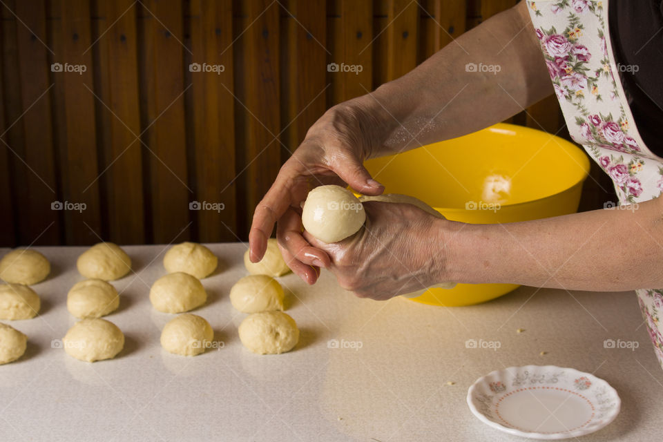 close up view of hands and dough