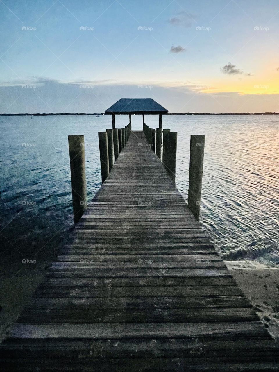 A beautiful dock in Florida over the Indian River Lagoon at sunset at House of Refuge in Stuart