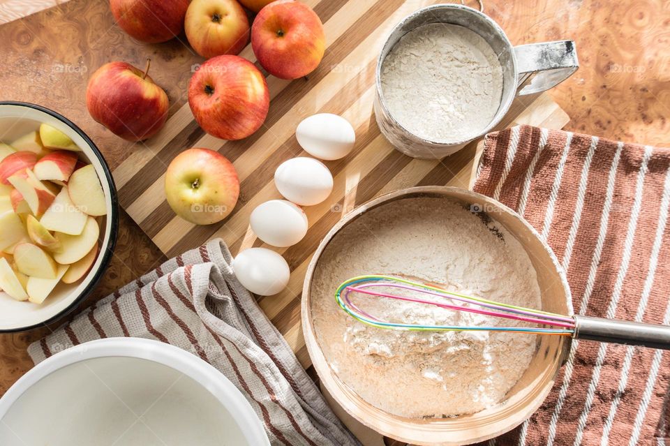 Making homemade puffed apple pie with eggs, sugar and flour.
