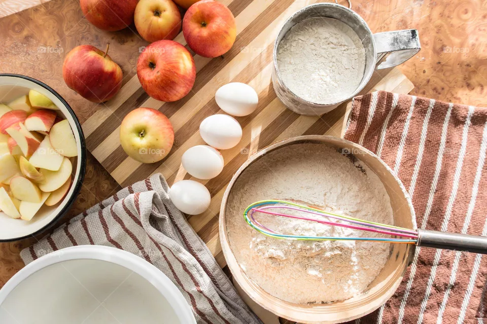 Making homemade puffed apple pie with eggs, sugar and flour.