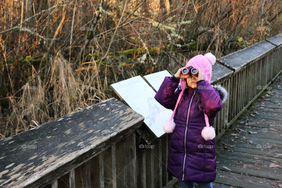 Girl out birdwatching in the forest