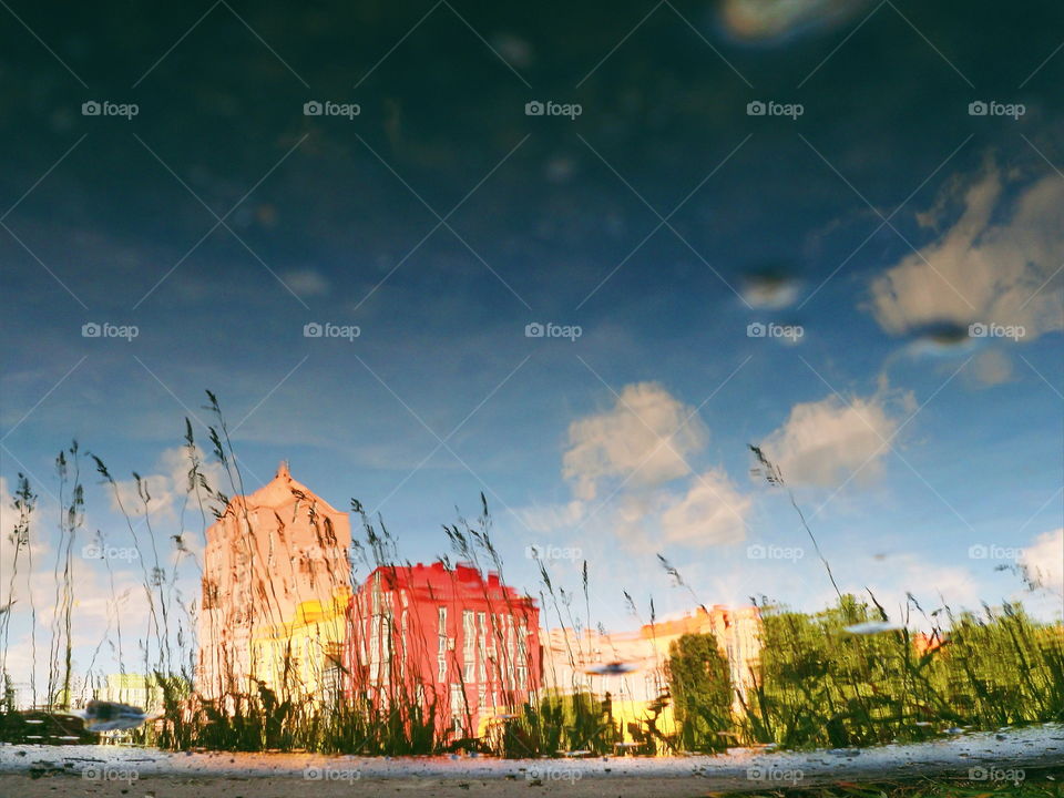 Mirror image of houses in a puddle, Kiev,