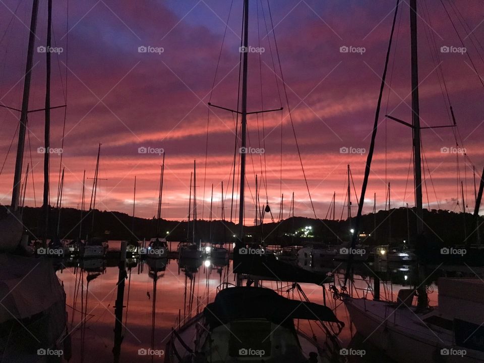 the day dawning in a marina with sailboats