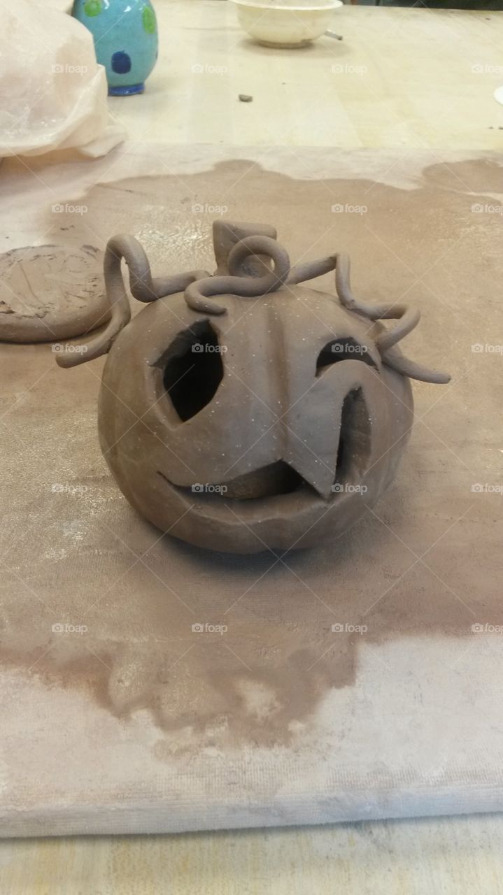 A cute little clay creation of a jack-o'-lantern