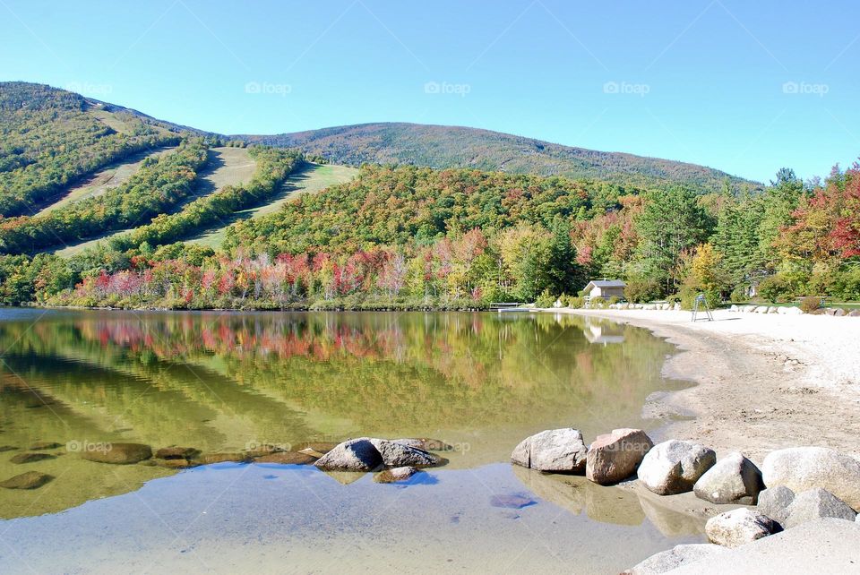 New England lake in autumn with mountains in the background 