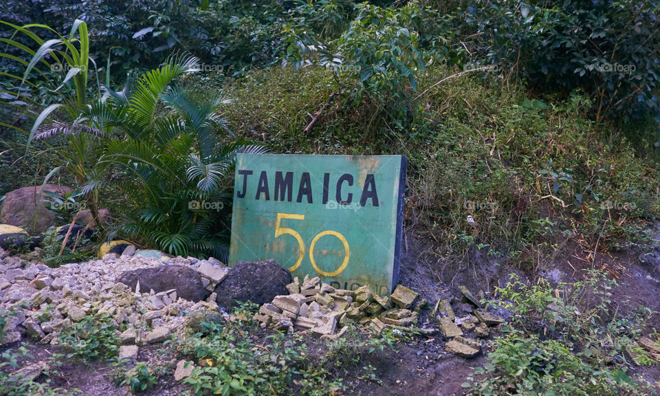 Portland Parish, Jamaica - January 1, 2014: Green Jamaica 50 sign by the side of the B1 road in the Blue Mountains region of the Portland Parish, Jamaica on New Years Day morning 2014. 