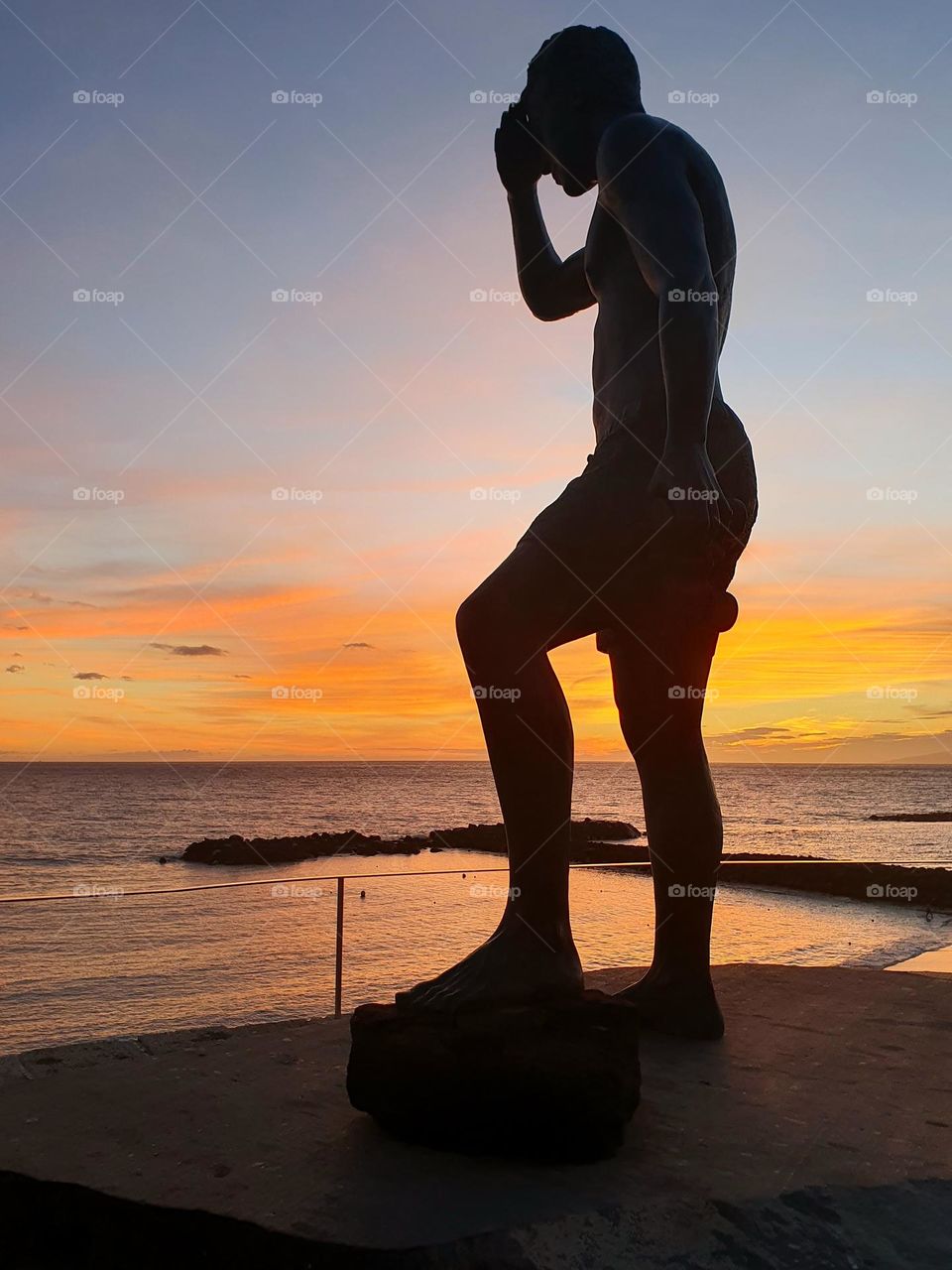 summer sunset at the beach- colourful and relaxing- stone man figur as an perfect match-  looking and dreaming and loves the view huge view