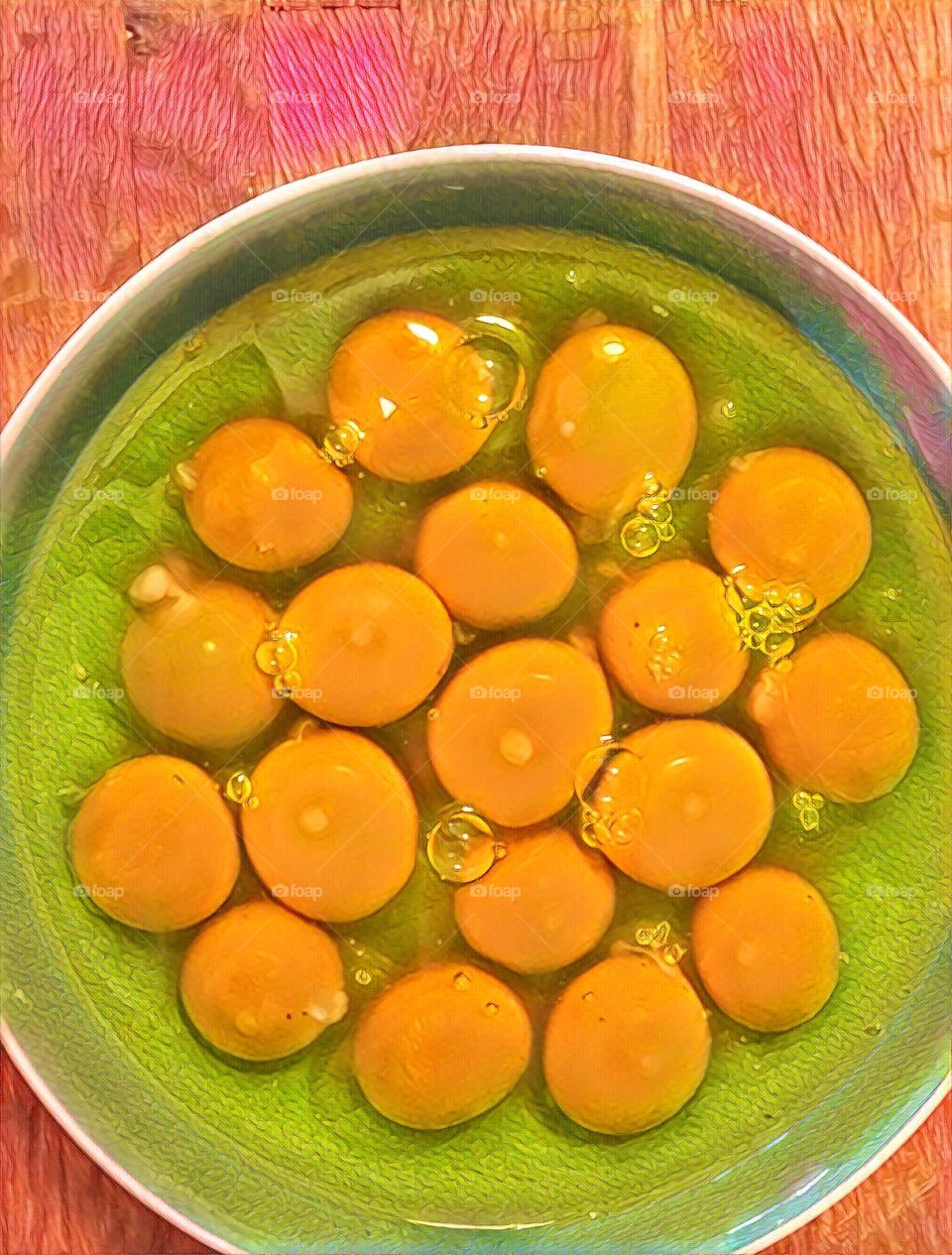 Prisma of eggs yoke and whites with a bowl