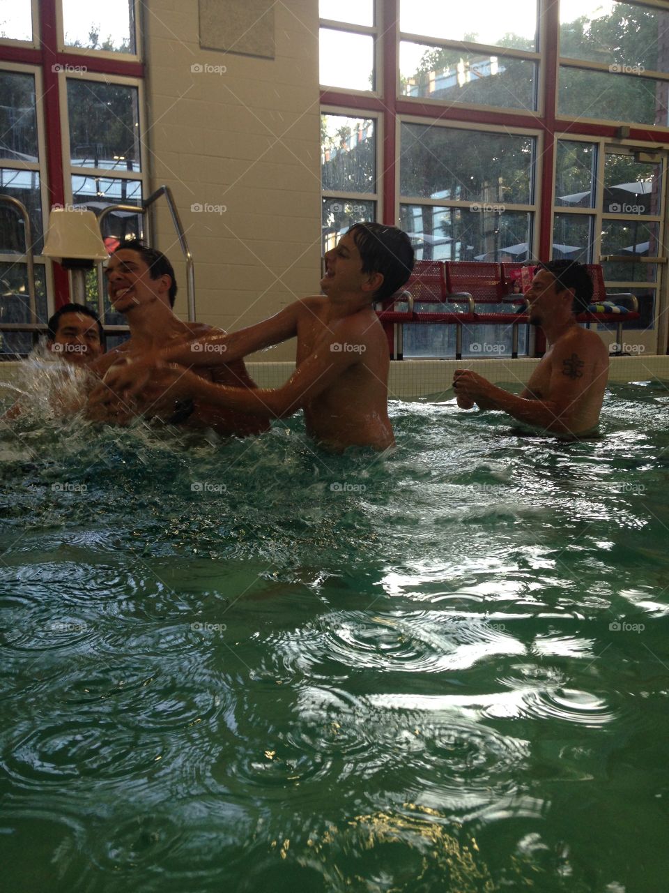 I call it. Boys competing to catch a football in a pool