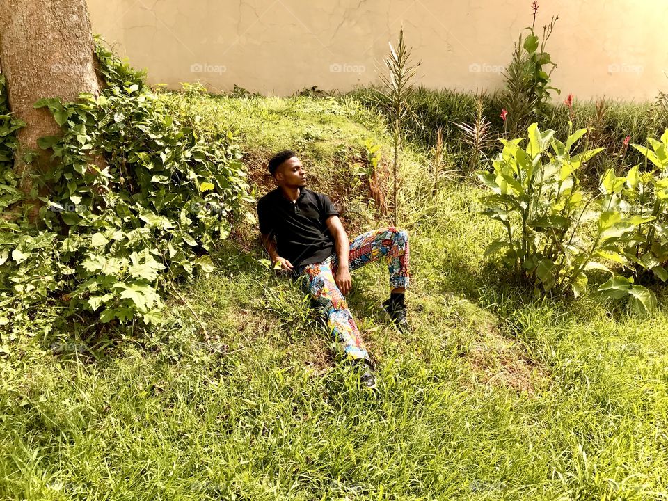 Man sitting on grass in natural setting 