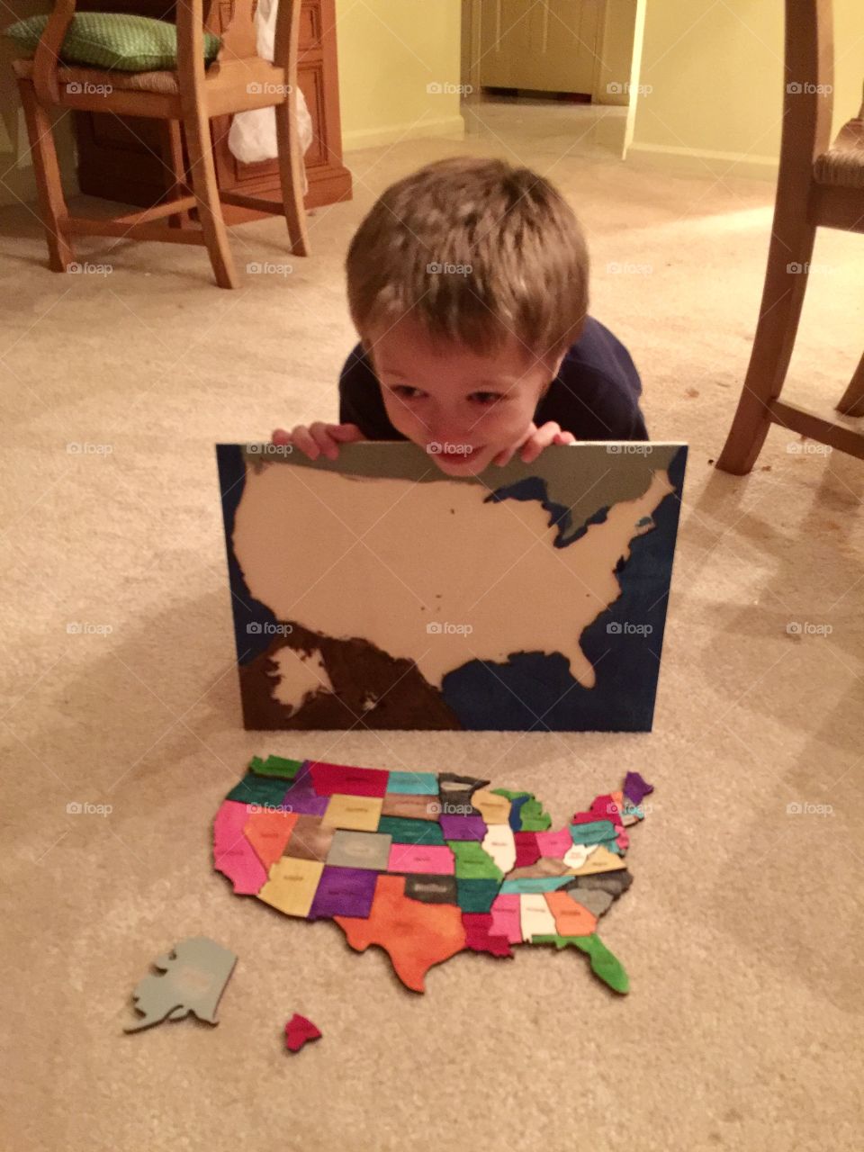Little boy with USA states puzzle 