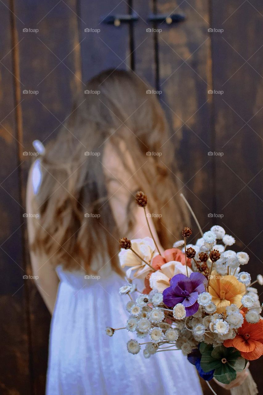 child offering flowers