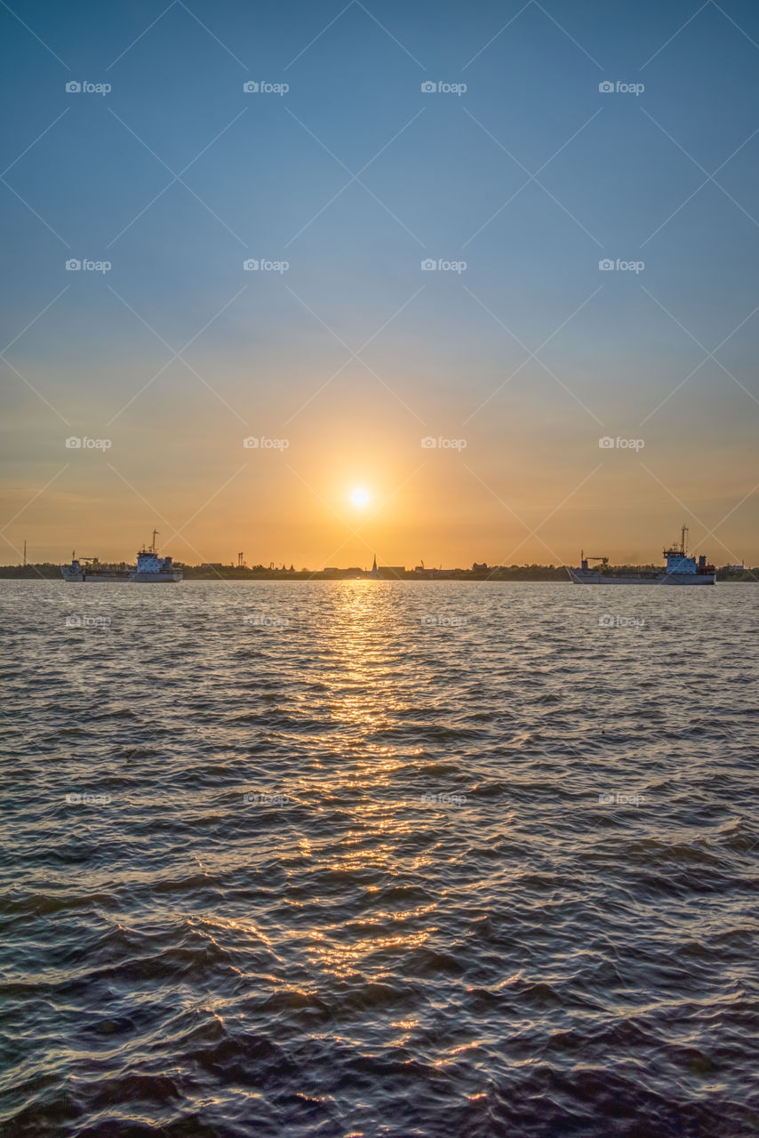 Golden sunset scene above Thai pagoda